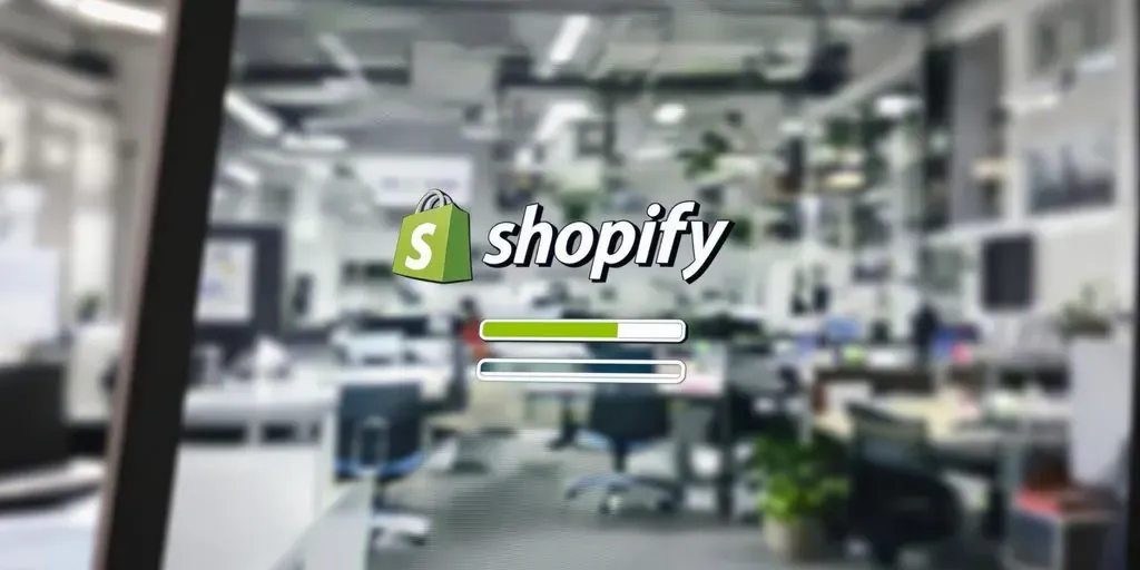 Shopify logo with a loading symbol on a screen.