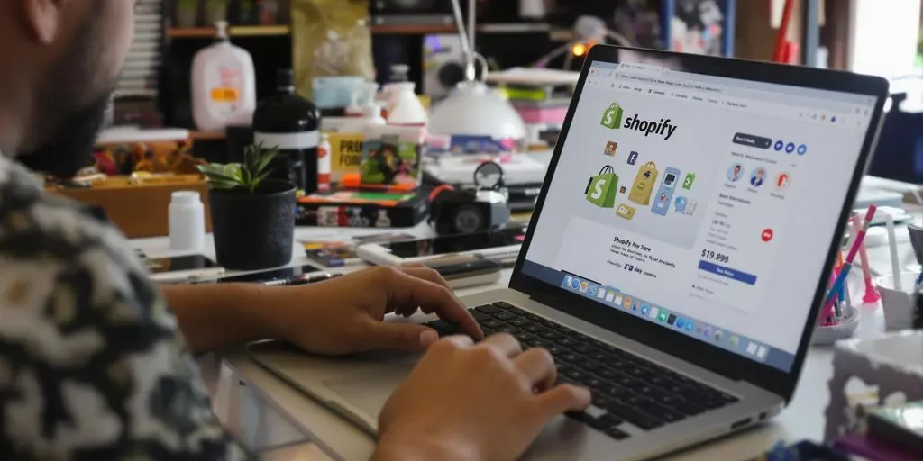 Entrepreneur working on Shopify with products around.