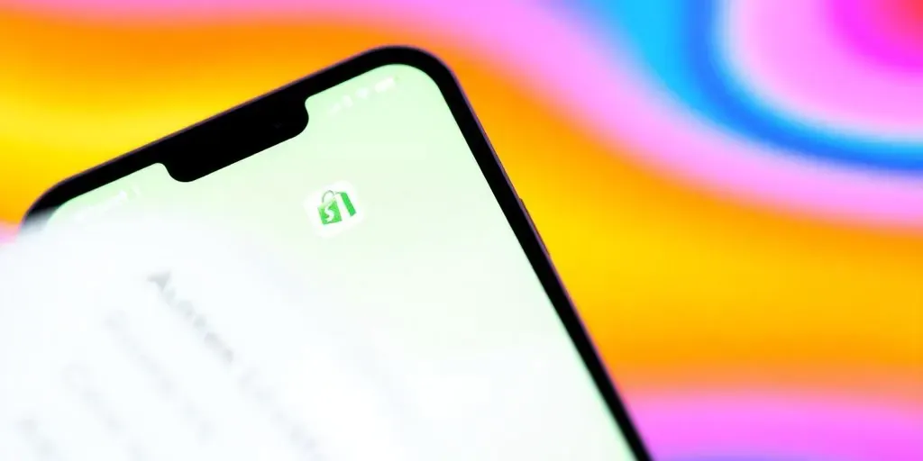 Smartphone displaying the Shopify Authenticator app for security.